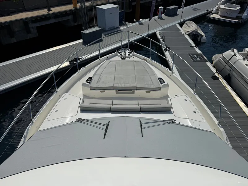 Slide: The Image of Foredeck of a modern yacht with sun loungers, surrounded by a marina. - 19