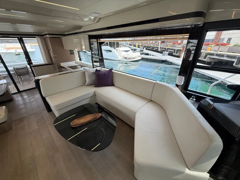 Slide: The Image of Interior of the 2022 Absolute 62 Fly with sleek white leather couch and modern design. - 37