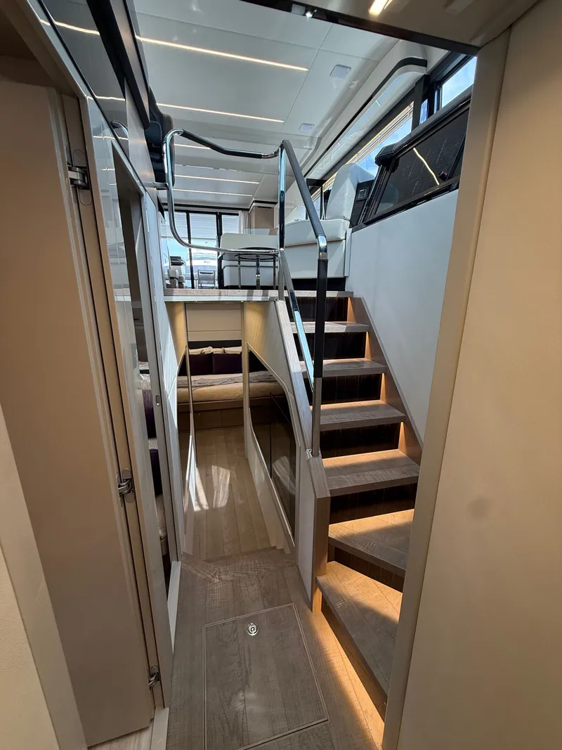 Slide: The Image of Interior of the 2022 Absolute 62 Fly with elegant staircase and modern design. - 43