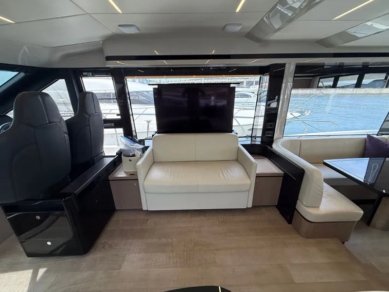 Slide: The Image of Interior of the 2022 Absolute 62 Fly with a sofa, TV, and large windows. - 38