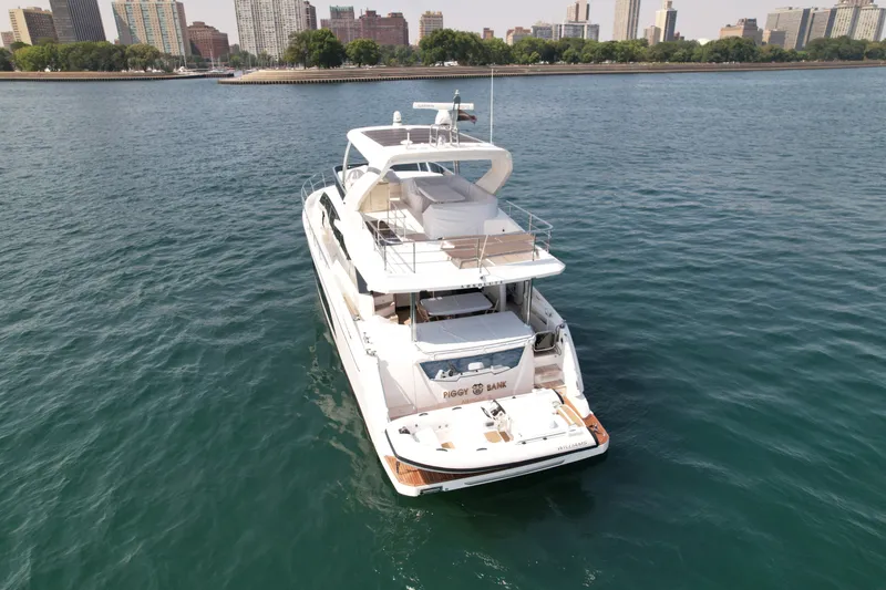 Slide: The Image of Absolute 62 Fly 2022 on calm water with a city skyline in the background. - 3
