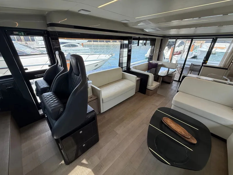 Slide: The Image of Interior of a luxury yacht with leather seating and large windows overlooking the marina. - 36