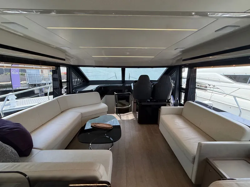 Slide: The Image of Interior of the 2022 Absolute 62 Fly with modern white sofas and large windows. - 34