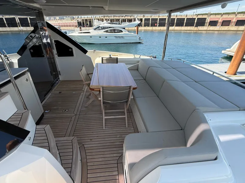 Slide: The Image of The image shows the aft deck of a luxury yacht with a large seating area and table. - 8