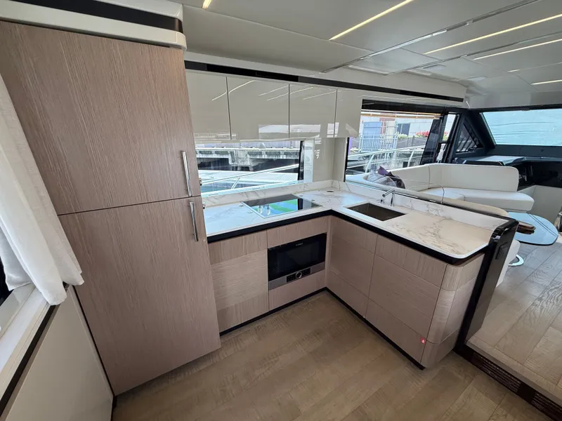 Slide: The Image of Modern yacht kitchen with wood cabinets, marble countertops, and large windows. - 40