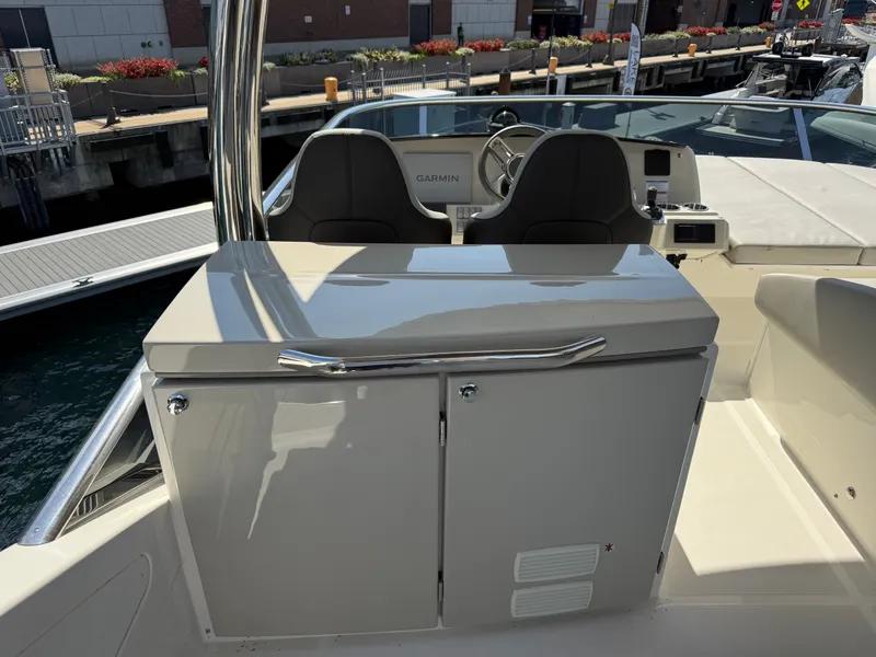 Slide: The Image of The image shows the cockpit of a 2022 Absolute 62 Fly with two seats and a helm station. - 28