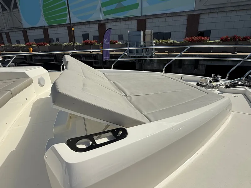 Slide: The Image of The image shows the sun deck of a 2022 Absolute 62 Fly with comfortable cushions. - 18