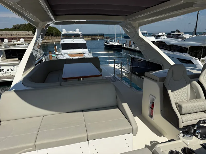 Slide: The Image of The image shows the deck of a 2022 Absolute 62 Fly with seating area and helm station. - 27