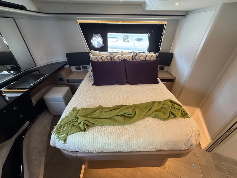Slide: The Image of Luxurious bedroom with a double bed, pillows, and blanket, surrounded by elegant wooden furniture. - 49