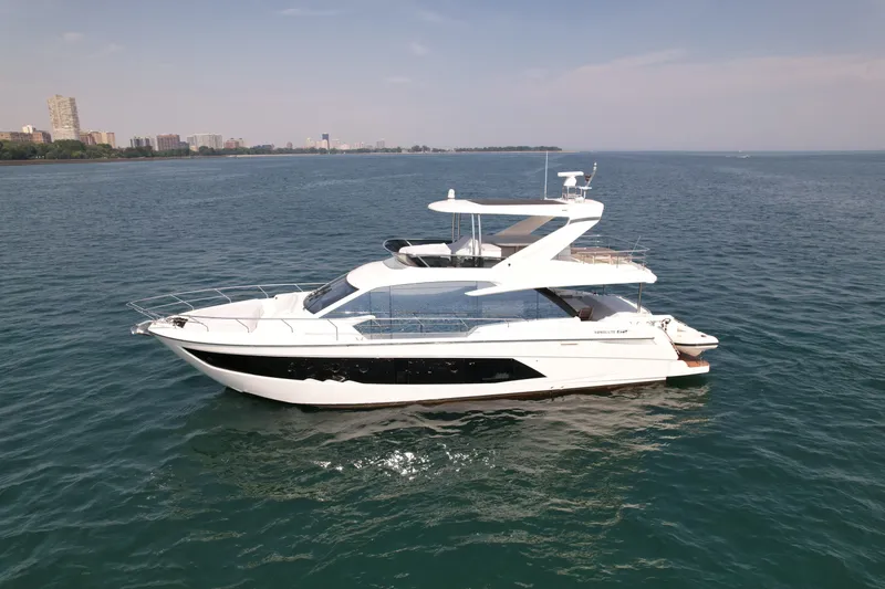 The Image of The 2022 Absolute 62 Fly is a sleek motor yacht on calm waters, featuring a modern design. - 0