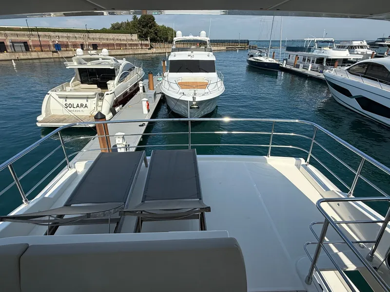 Slide: The Image of View from the flybridge of a luxury yacht overlooking a calm dock with several boats. - 20