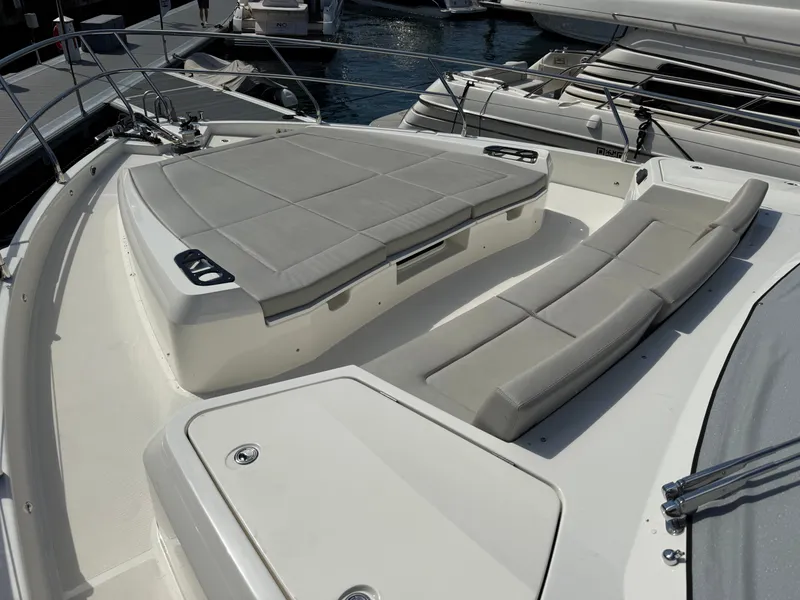 Slide: The Image of The image shows the foredeck of a 2022 Absolute 62 Fly with comfortable lounging areas. - 16
