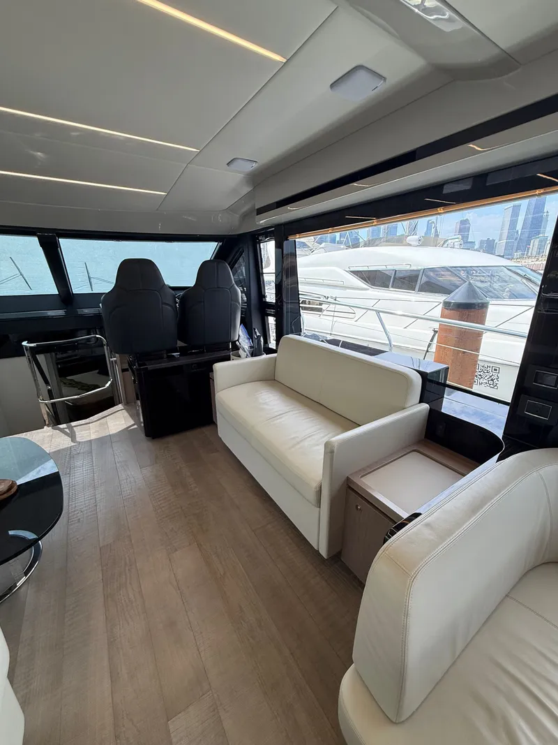 Slide: The Image of Interior of the 2022 Absolute 62 Fly with modern seating and large windows. - 35
