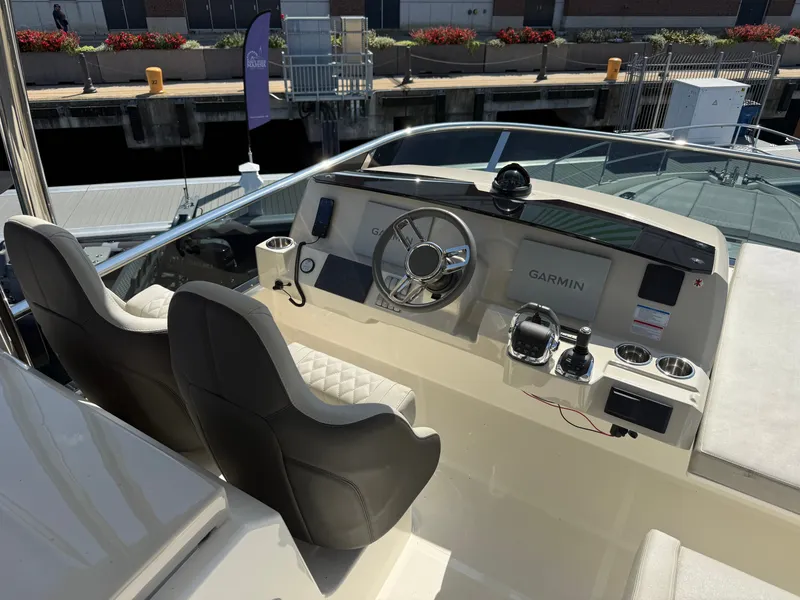 Slide: The Image of The image shows the helm of a 2022 Absolute 62 Fly with modern navigation equipment. - 32