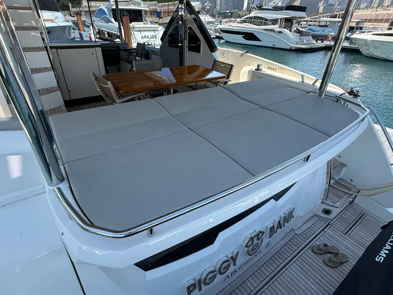 Slide: The Image of The image shows the stern of a 2022 Absolute 62 Fly with a large sunbed and a table in the background. - 4