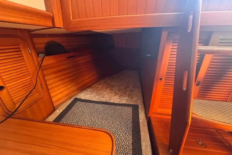Slide: The Image of Interior of 1986 Tashing Tashiba 31 sailboat with wooden paneling and carpeted floor. - 18