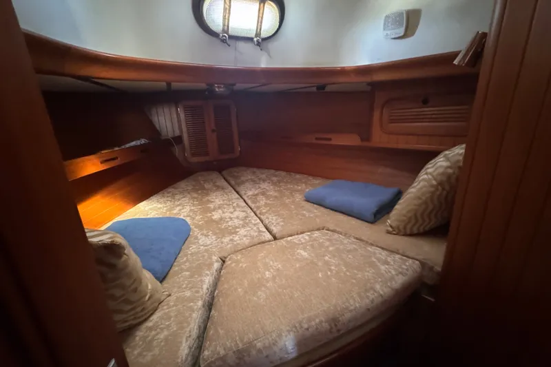 Slide: The Image of Cozy cabin interior of 1986 Tashing Tashiba 31 sailboat with cushions and wooden finish. - 23