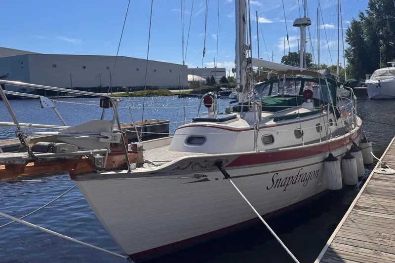 Slide: The Image of 1986 Tashing Tashiba 31 sailboat named Snapdragon docked at a marina. - 1