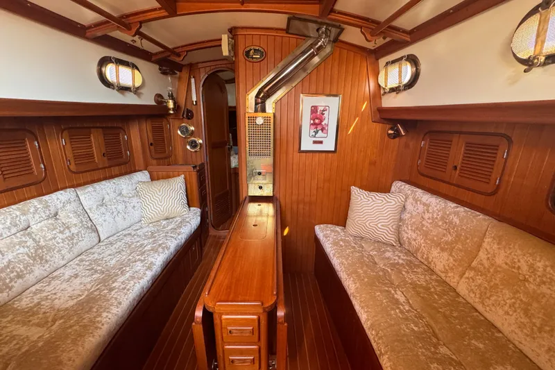 Slide: The Image of Cozy 1986 Tashing Tashiba 31 yacht interior with wood paneling and plush seating. - 19