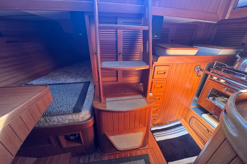 Slide: The Image of Interior of 1986 Tashing Tashiba 31 sailboat with wooden cabinetry and compact kitchen. - 26