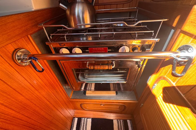 Slide: The Image of Compact kitchen area in a 1986 Tashing Tashiba 31 sailboat with stove and kettle. - 15