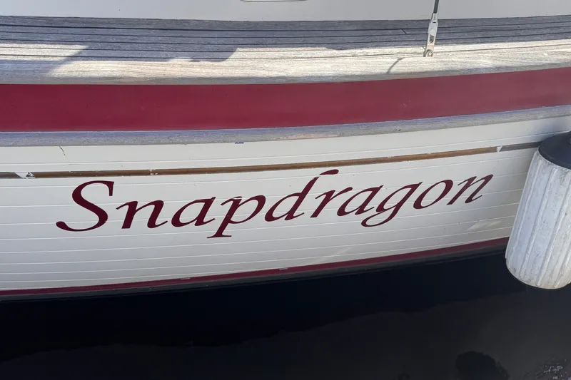 Slide: The Image of 1986 Tashing Tashiba 31 boat named "Snapdragon" with red and white detailing. - 38