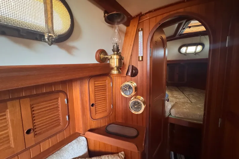 Slide: The Image of Vintage 1986 Tashing Tashiba 31 yacht interior with wooden paneling and nautical instruments. - 21
