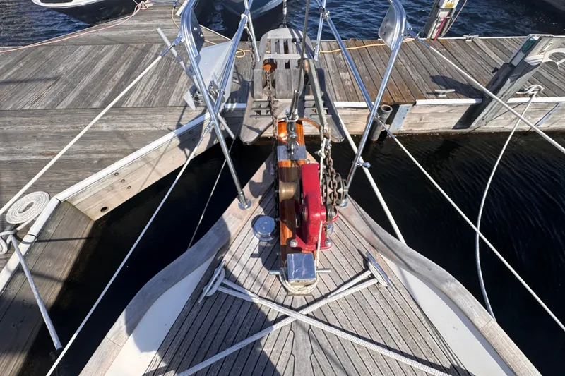 Slide: The Image of Bow of 1986 Tashing Tashiba 31 sailboat docked, featuring anchor and deck details. - 35