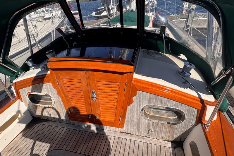 Slide: The Image of Cockpit of 1986 Tashing Tashiba 31 sailboat with wooden accents and nautical equipment. - 9