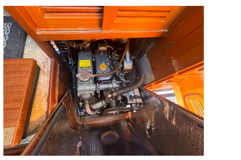 Slide: The Image of Engine compartment of a 1986 Tashing Tashiba 31 sailboat, showcasing mechanical components. - 30