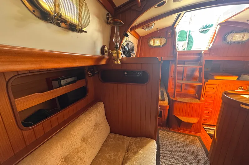 Slide: The Image of Interior of 1986 Tashing Tashiba 31 sailboat with wooden paneling and cozy seating. - 25