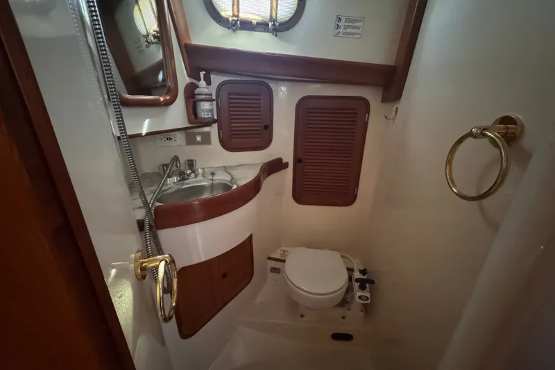 Slide: The Image of Compact bathroom in 1986 Tashing Tashiba 31 yacht with sink, toilet, and wooden accents. - 22
