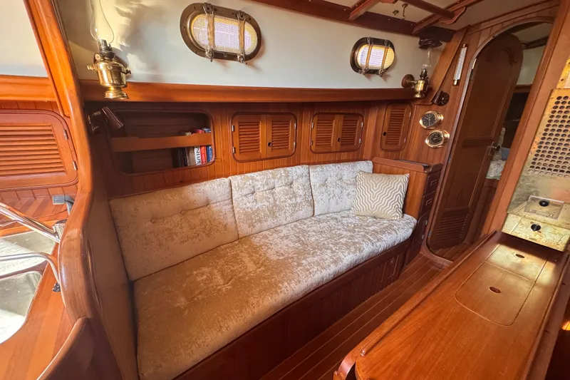 Slide: The Image of Cozy interior of 1986 Tashing Tashiba 31 sailboat with plush seating and wooden accents. - 20
