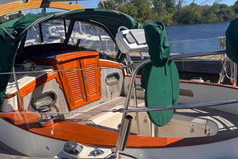Slide: The Image of 1986 Tashing Tashiba 31 sailboat cockpit with wooden accents and green covers. - 4