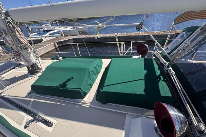 Slide: The Image of Sailboat deck of 1986 Tashing Tashiba 31 with green covers at marina. - 6