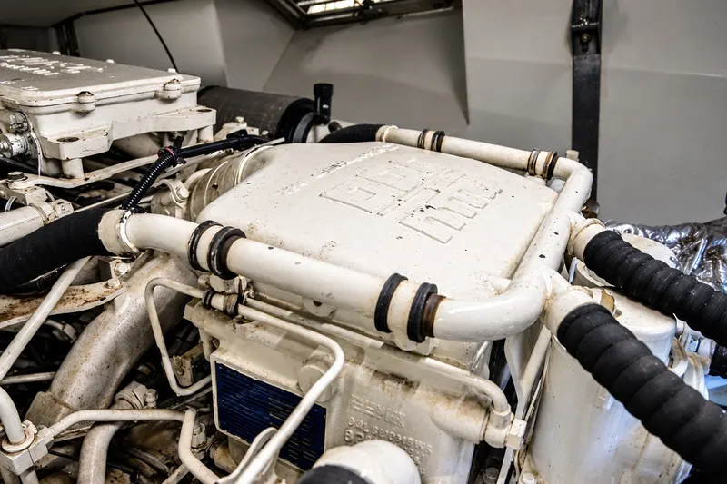 Slide: The Image of Engine compartment of a 2004 Azimut 62 yacht, showcasing mechanical components and piping. - 35