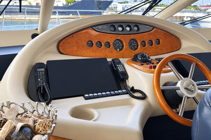 Slide: The Image of Helm of 2004 Azimut 62 yacht with wooden steering wheel and control panel. - 28