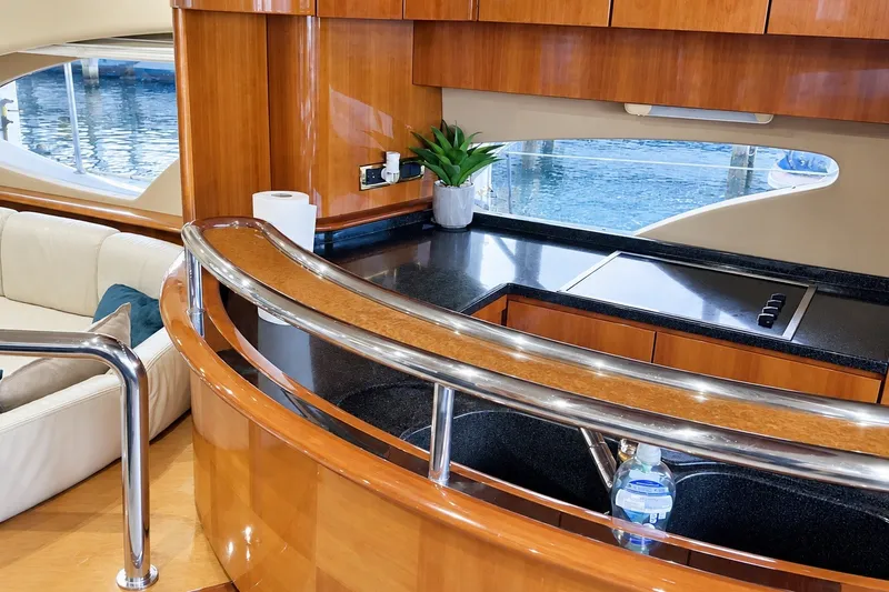 Slide: The Image of Luxurious interior of a 2004 Azimut 62 yacht with sleek kitchen and elegant wood finishes. - 23