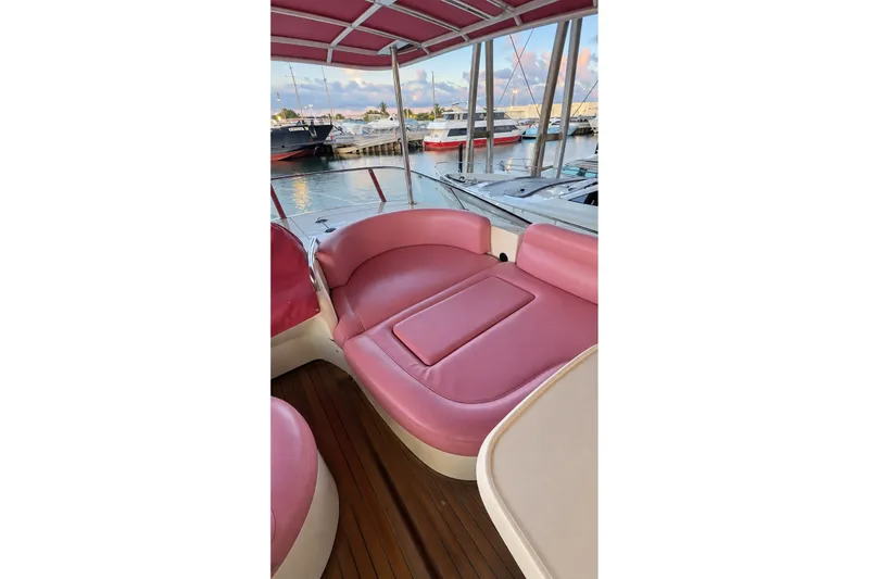 Slide: The Image of Luxurious 2004 Azimut 62 yacht interior with pink seating, docked at marina. - 52