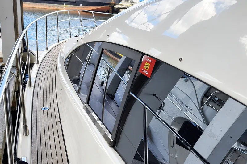 Slide: The Image of 2004 Azimut 62 yacht with sleek design, docked by the water. - 42