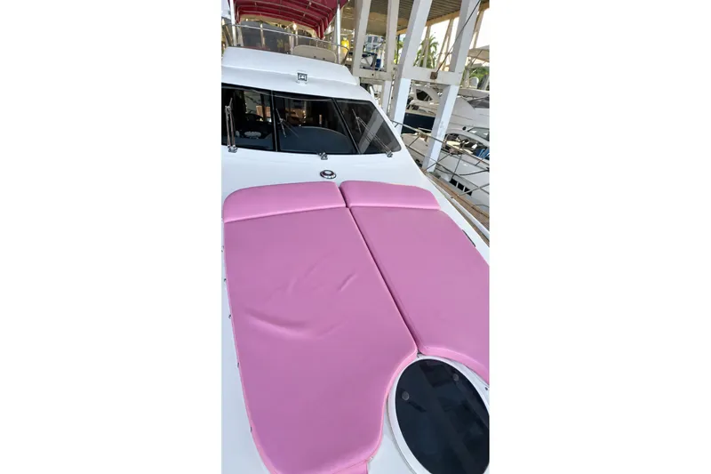 Slide: The Image of 2004 Azimut 62 yacht with pink sunbathing cushions on deck. - 57