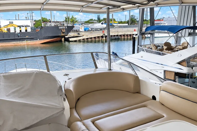 Slide: The Image of Luxurious 2004 Azimut 62 yacht interior with waterfront view and nearby docked boats. - 20