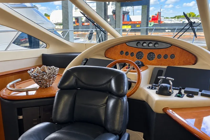 Slide: The Image of Luxurious 2004 Azimut 62 yacht helm with leather chair and elegant dashboard controls. - 29