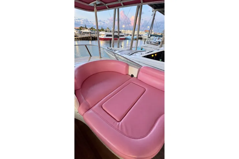 Slide: The Image of Pink seating area on a 2004 Azimut 62 yacht, docked at a marina. - 49