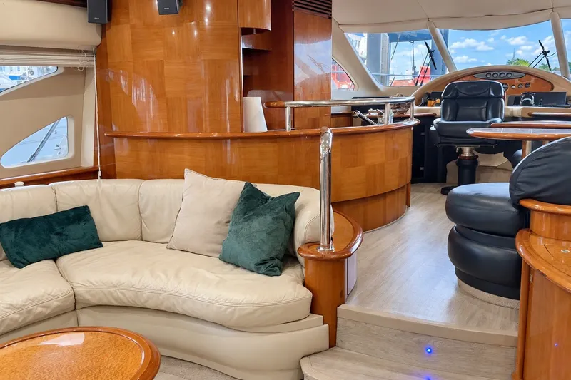 Slide: The Image of Luxurious interior of a 2004 Azimut 62 yacht with elegant wood finishes and plush seating. - 32