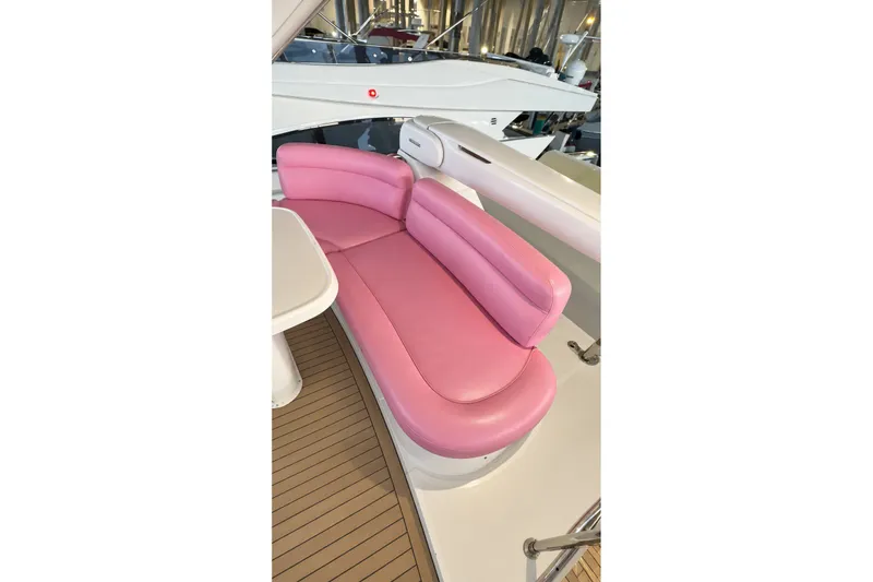 Slide: The Image of Pink seating area on 2004 Azimut 62 yacht with white table and wooden deck. - 51