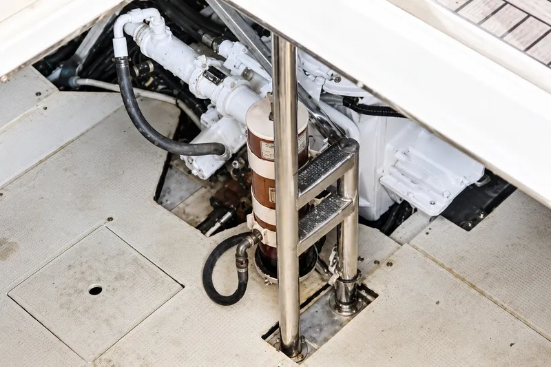 Slide: The Image of Engine compartment of a 2004 Azimut 62 yacht, showcasing mechanical components and piping. - 34