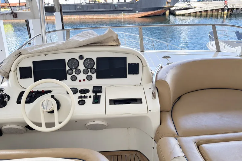 Slide: The Image of Cockpit of a 2004 Azimut 62 yacht with steering wheel and navigation instruments. - 21