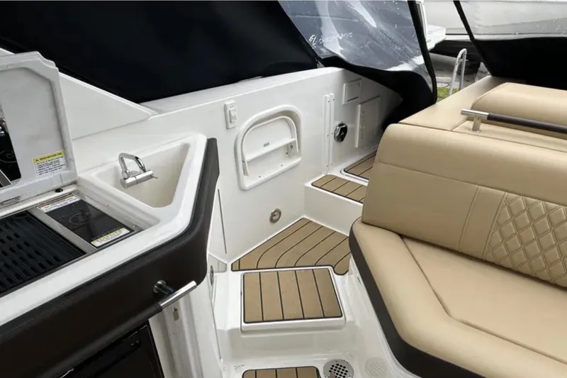 Slide: The Image of 2024 Sea Ray SLX 310 boat interior with seating and kitchenette area. - 36