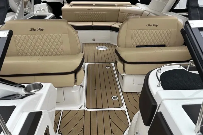 Slide: The Image of Luxurious interior of 2024 Sea Ray SLX 310 boat with tan leather seating and teak flooring. - 44